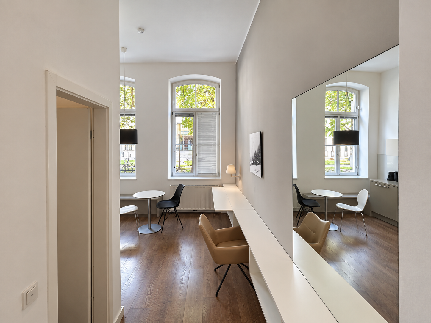 Apartment S im Erdgeschoss des Haupthauses: Wohnbereich mit Schreibtisch und Spiegel